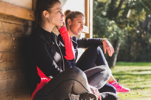 Free photo sportswomen resting outdoors