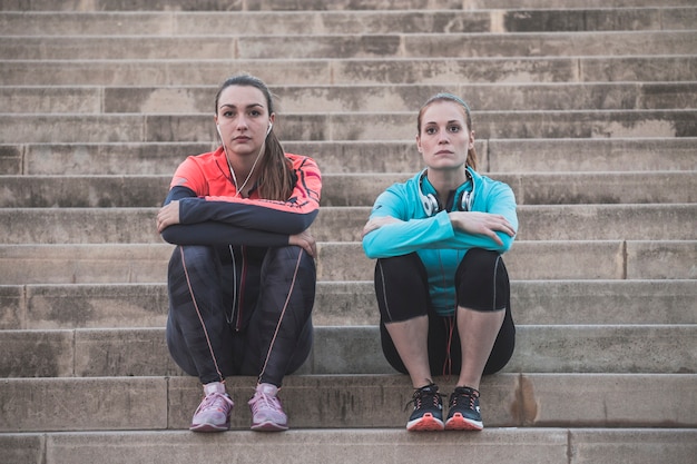 Sportswomen sitting with crossed arms