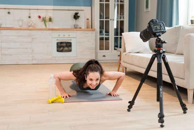 Sporty blogger doing pushups in front of camera