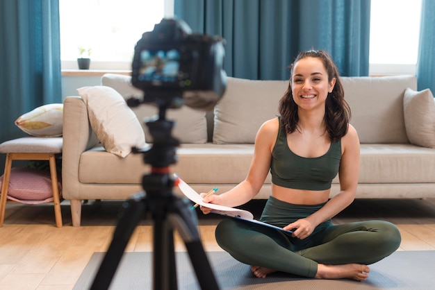 Free photo sporty blogger sitting in front of camera