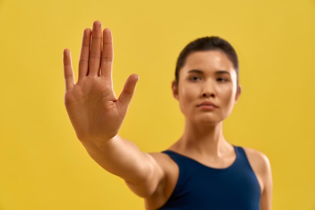 Sporty brunette practicing yoga indoors