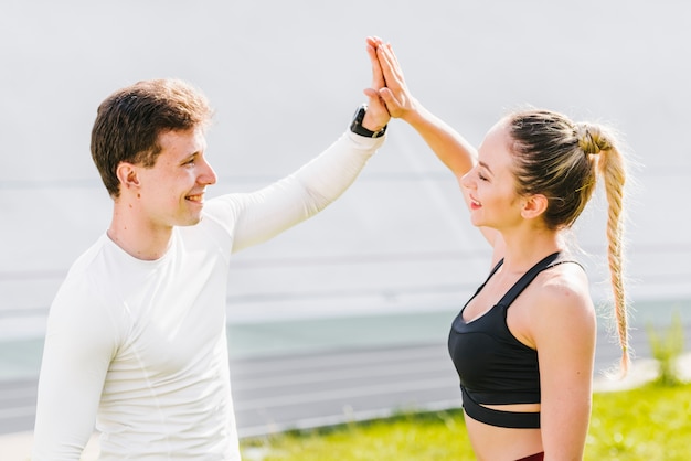 Free photo sporty couple high-fiving each other