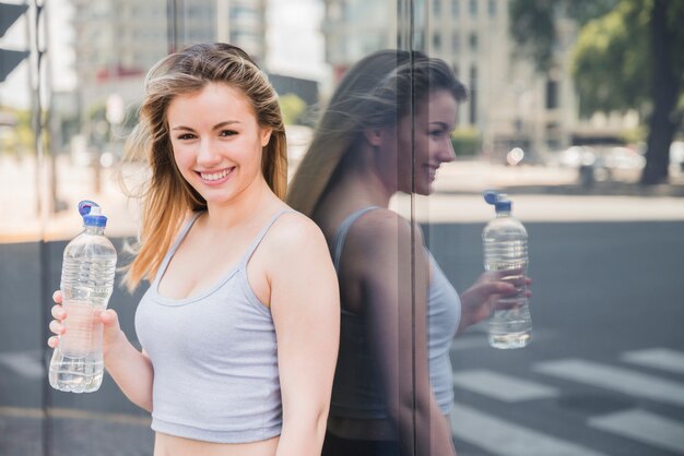 Sporty girl posing with bottle of water