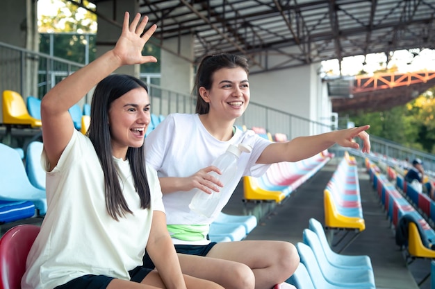 sporty-happy-women-sitting-bleachers-day