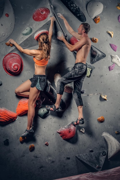 Full-length shot of a young man in sportive attire standing near a climbing  wall and looking aside Stock Photo - Alamy