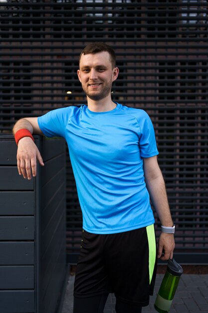 Sporty man portrait over gray background