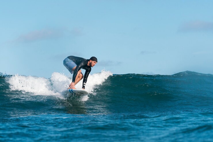 Free Photo sporty man surfing in hawaii
