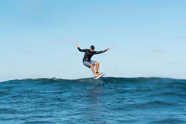 Sporty man surfing in hawaii