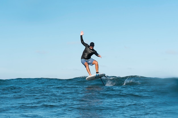 Sporty man surfing in hawaii