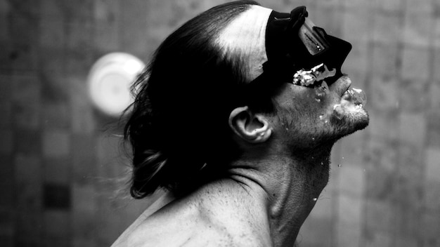 Sporty man swimming in mask in pool