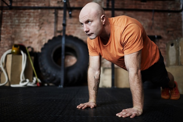 Young sportsman doing plank exercise on a fitness mat ...