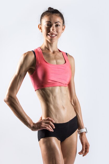 sporty model with beautiful body posing in studio