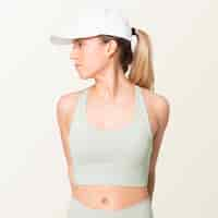 Free photo sporty woman in green sportswear and cap facing side