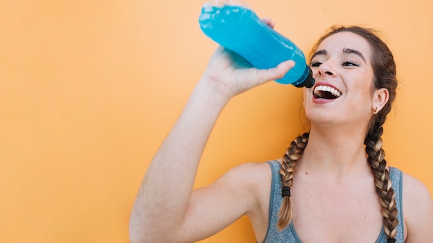 Sporty woman having blue drink