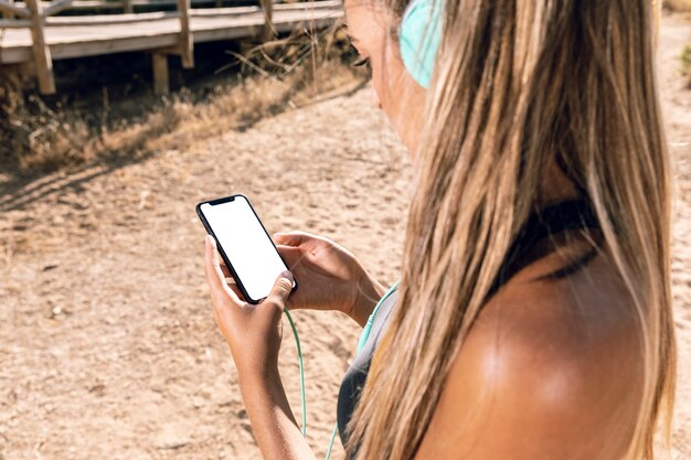 Sporty woman looking at her phone mock-up