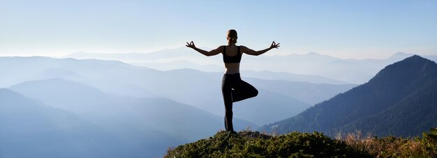 Sporty woman meditating on fresh air