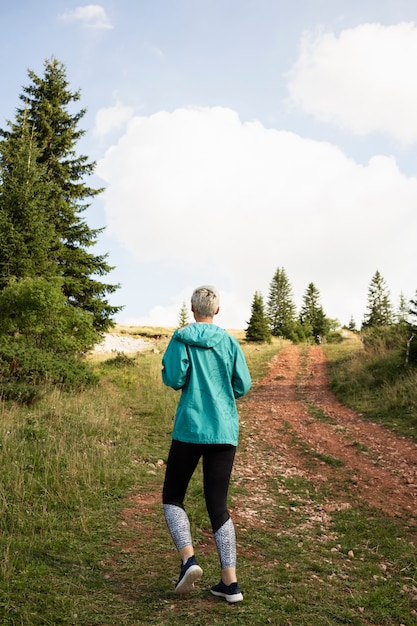 Free photo sporty woman running in nature