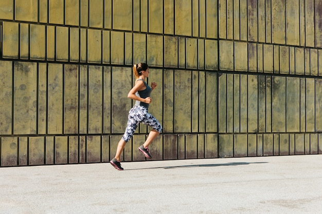 Sporty woman running in urban environment