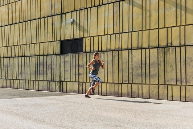 Sporty woman running in urban environment
