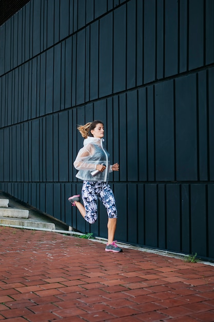 Sporty woman running in urban environment