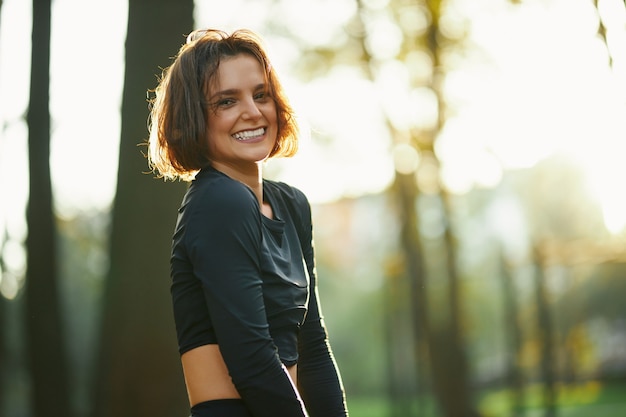 Sporty woman standing at park