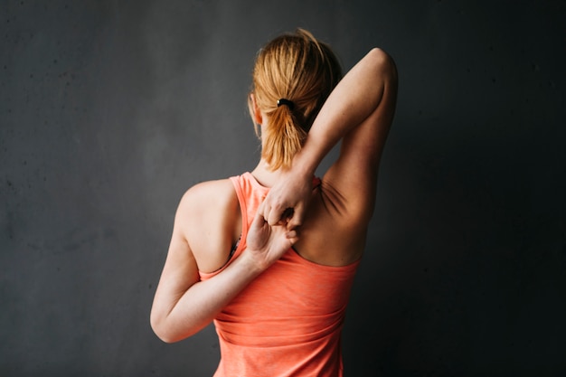 Sporty woman stretching in urban environment