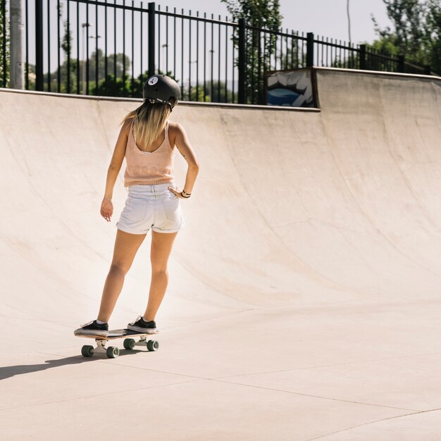Sporty young girl with helmet skating