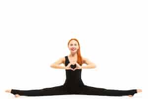 Free photo sporty young woman doing splits yoga asana