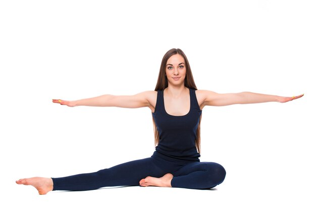 Sporty young woman doing yoga practice isolated on white background