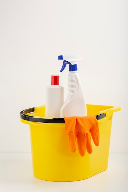 Free photo spray bottles in bucket front view