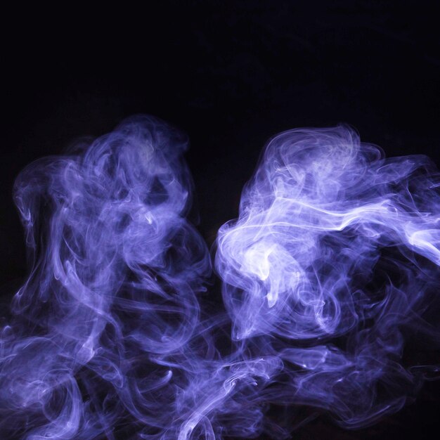 Spread of purple smoke overlay on black background