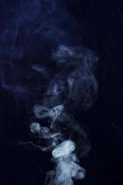 Spread white smoke on black background