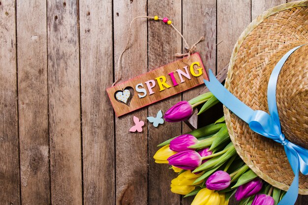 Spring background with cute flowers and hat