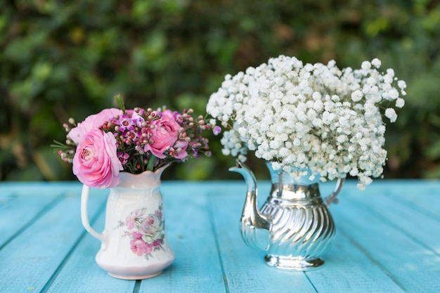 Spring background with teapot and vase