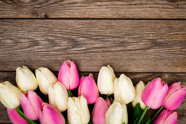 Spring composition with tulips on wooden