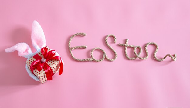 Spring Easter festive.Easter creative inscription on pink with items of Easter decor.