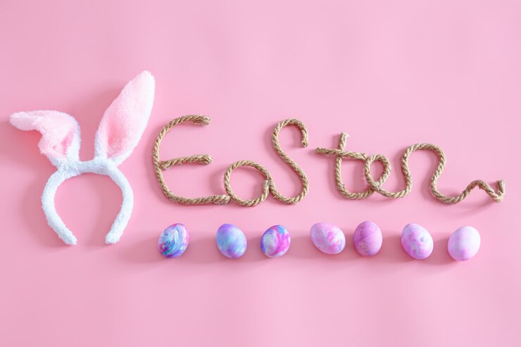 Free Photo spring easter festive.easter creative inscription on pink with items of easter decor.