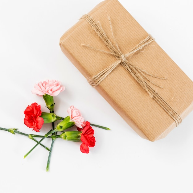 Spring flowers background with present box