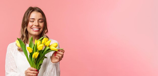 Spring happiness and celebration concept closeup portrait of lovely romantic smiling girl touching p