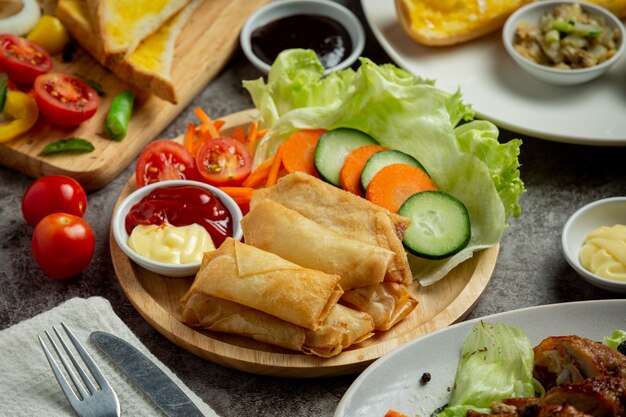 Spring rolls with cheese on dark background