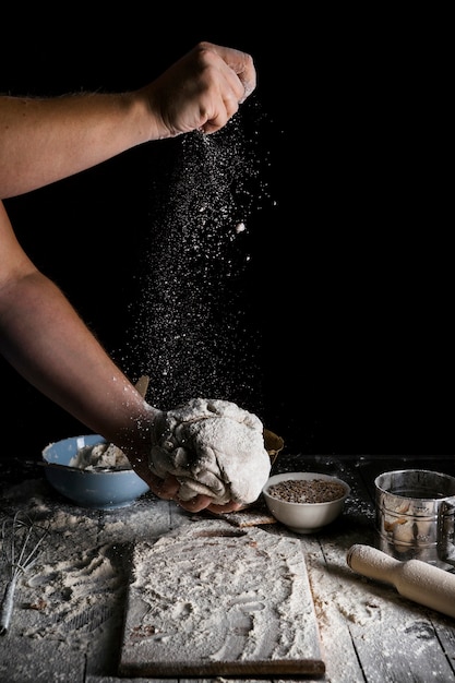 Sprinkling the piece of dough with wheat flour