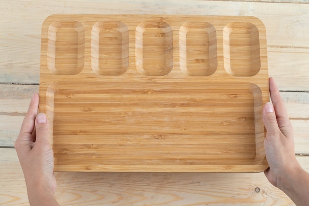 Square breakfast platter with carved pieces on it. 