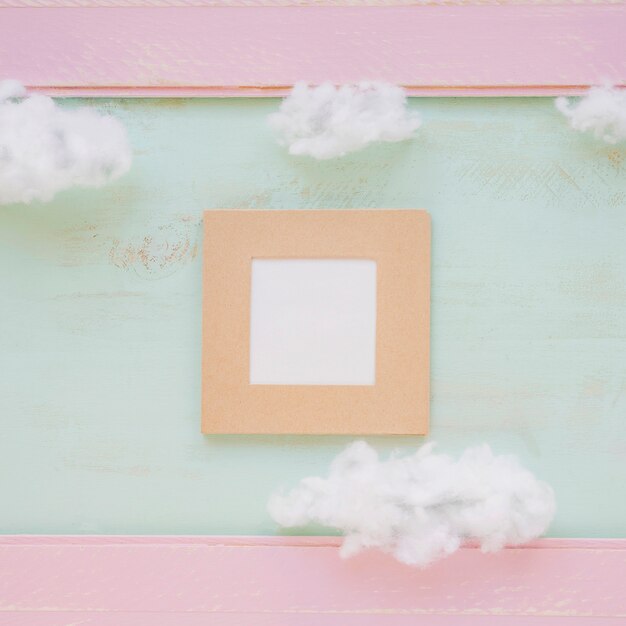 Square frame and clouds over color backdrop