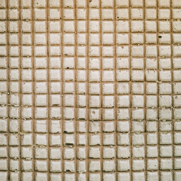 コンクリートの壁の背景に正方形のパターン