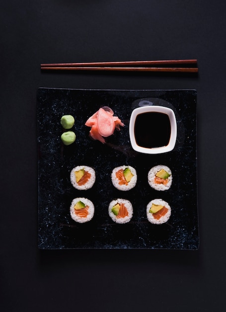 Foto gratuita piatto quadrato con sushi e condimenti