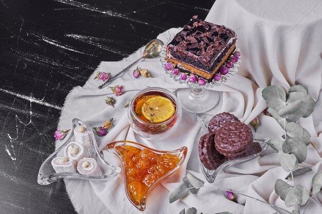 A square slice of chocolate cheesecake with cookies.