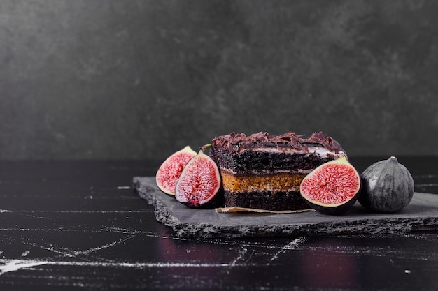 A square slice of chocolate cheesecake with figs.