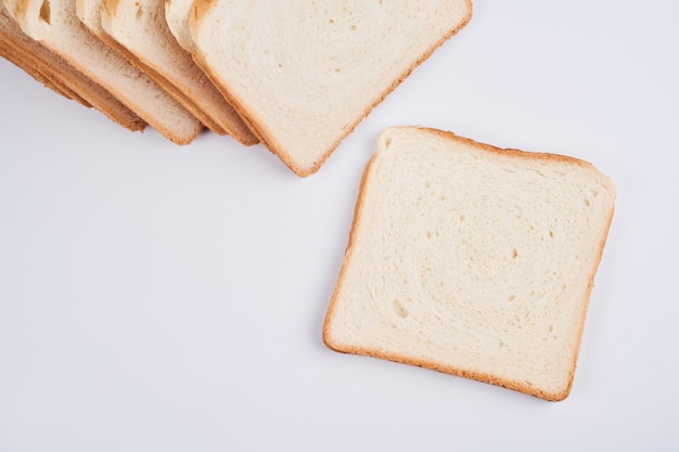 Square slices of toast sandwich bread isolated on white background close up