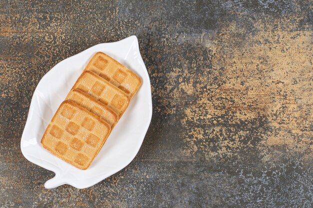 Square sweet crackers on leaf shaped plate. 