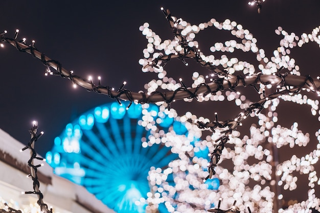 Square with lights and ferris wheel